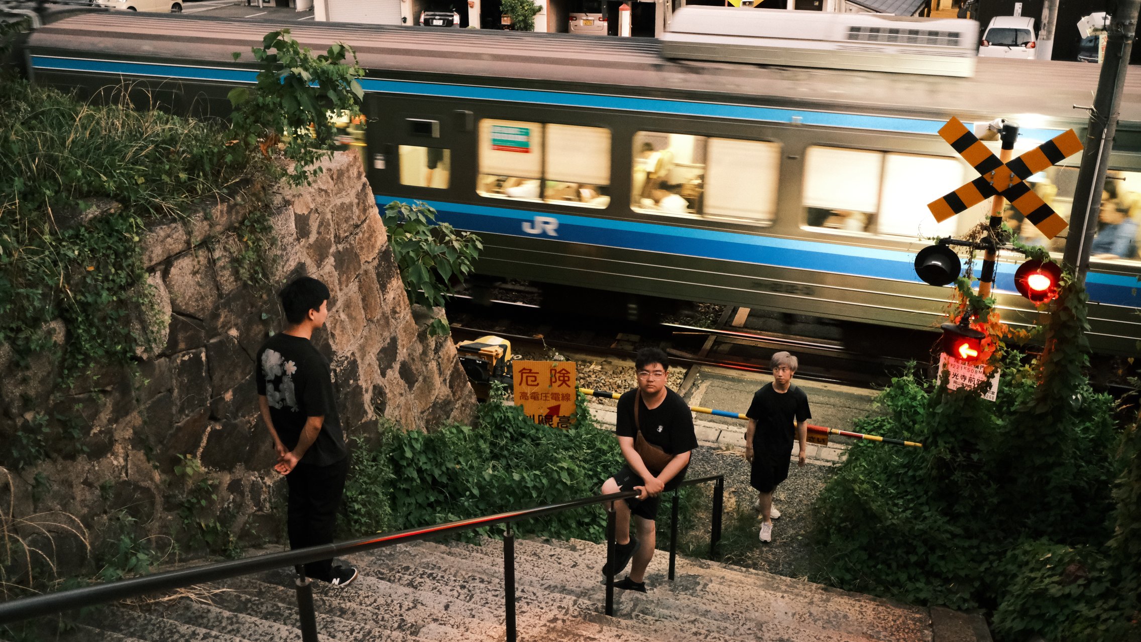 Friends at a JR rail crossing in Japan
